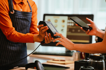 A smiling barista serves a customer at a modern café counter, showcasing friendly service, small business spirit, and coffee culture.