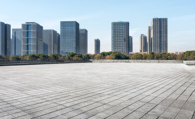 Expansive Urban Plaza with Modern Skyscrapers Under Clear Blue Sky