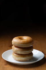 several donuts stacked on a plate