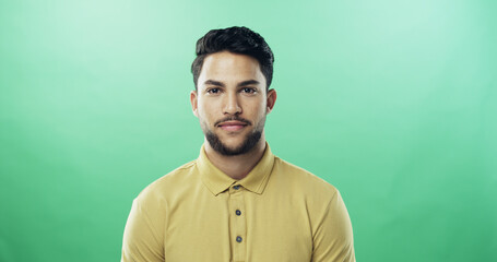 Fototapeta premium Smile, man and portrait of teacher in studio with confidence for career growth in education. Happy, mockup space and sports educator from brazil with pride for high school job by green background.