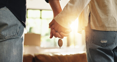 Couple, holding hands and new home with keys for moving in, fresh start or beginning together. Back...