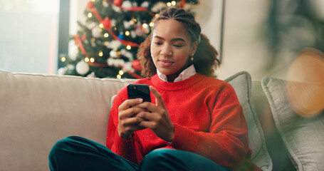Christmas, ecommerce and phone with black woman in living room of home for online shopping. App, browsing and retail checkout with African person in apartment to purchase gift or present on internet