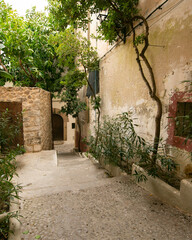 Fototapeta premium Streets and views of the ancient walled citadel of Dalt Vila, a UNESCO World Heritage Site, on the island of Ibiza in Spain.