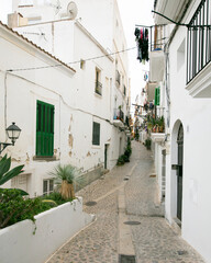 Fototapeta premium Streets and views of the ancient walled citadel of Dalt Vila, a UNESCO World Heritage Site, on the island of Ibiza in Spain.