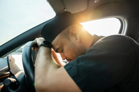 Young asian muslim islamic driver was drowsy. Yawned and was about to fall asleep in car doze off. Driving for a long time sleep deprivation. Campaign for safe driving