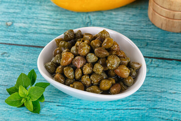 Pickled canned capers in the bowl