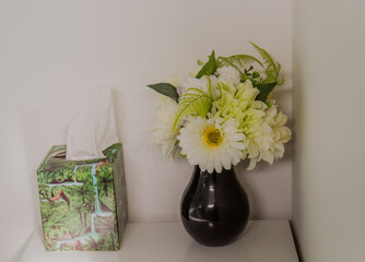 Fake flower bouquet next to tissue box
