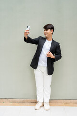 businessman in a suit taking selfie with mobile phone