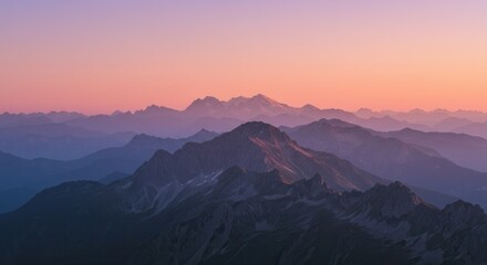 Obraz premium Sunset over majestic mountain range with layers of distant peaks.
