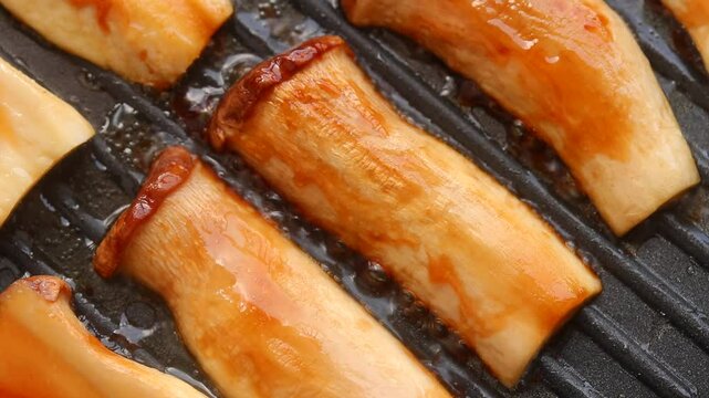 Fried  Eryngii (King Oyster) Mushroom Sliced With Soy Sauce On Grill Pan. Top view Shots