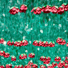chain of arctificial red roses embedded in green plastic leaves hanging in the sky