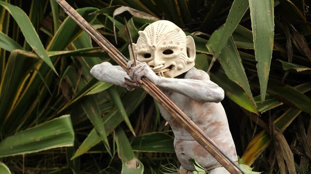 Asaro Mudmen tribe bow hunting. Papuan tribe dance. Mount Hagen tribe festival. Cultural event. Indigenous men in native costumes. High quality 4k footage