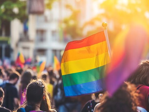 flag rainbow pride day LGBT waving on the street outdoors symbol gay lesbian peace LGBTQ bisexual homosexual transgender love parade freedom event - Powered by Adobe