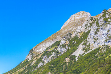 Alpine mountain and hill landscape panorama blue sky Tyrol Austria.