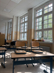 Sunlit Classroom with Wooden Desks and Chairs