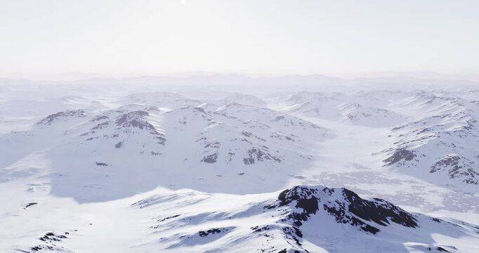 Vast snow covered mountains rise under a clear sky, creating a serene arctic landscape. The rugged terrain showcases the beauty of nature in its untouched form.