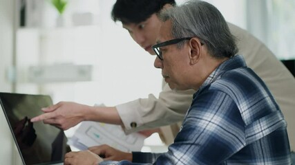 Asian man coding trainer (Teacher) and retired adults learn coding, software, and cyberspace skills through workshops led by professionals, promoting connection, innovation, and lifelong education.