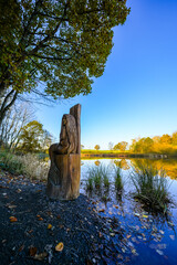 View of the autumn landscape at the Holzmaar near Gillenfeld. Idyllic nature by the lake in the Volcanic Eifel region of Rhineland-Palatinate.

