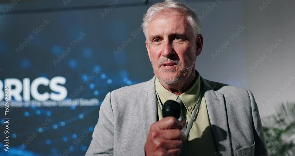 Poster education, presentation and speech with business man on stage in auditorium for brics seminar. confe