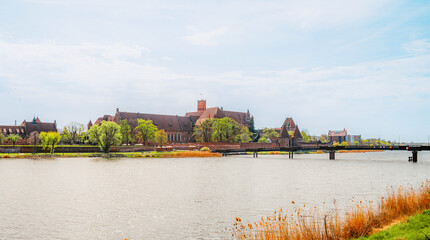 Fototapeta premium Teutonic Malbork castle in Pomerania region with Nogat river in Poland