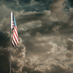 American flag waving under a cloudy sky