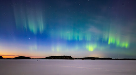 Northern lights dancing over lake in Farnebofjarden national park in north of Sweden