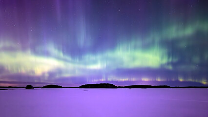 Northern lights dancing over lake in Farnebofjarden national park in north of Sweden
