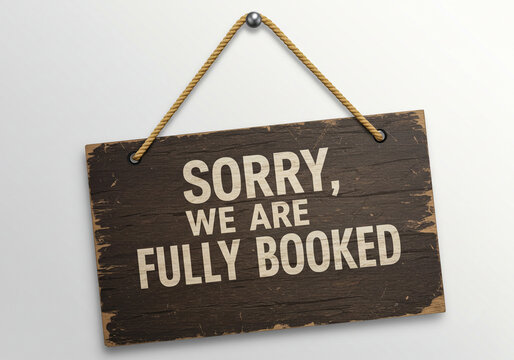 Sorry we are fully booked sign hanging on a wall with a rope and metal sphere on a white background