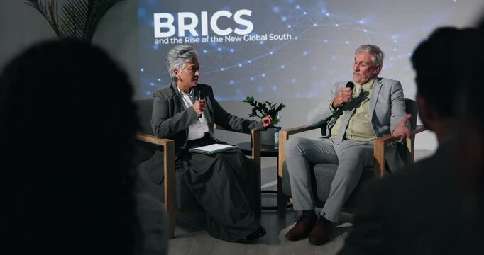 Conference, interview and speech with business people on stage in auditorium for BRICS seminar. Discussion, education and update with speakers on podium for lecture on emerging economies cooperation