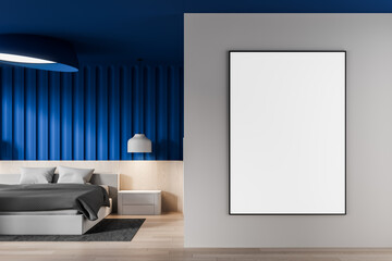 Modern bedroom interior with empty vertical poster mockup on grey wall and bold blue accent backdrop design in bright minimalist layout. 3D Rendering
