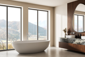 Modern minimalist bathroom interior with freestanding tub and mountain view through large windows in natural light setting. 3D Rendering