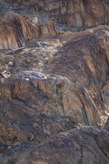 Lines and textures in rocks of mountain cliff
