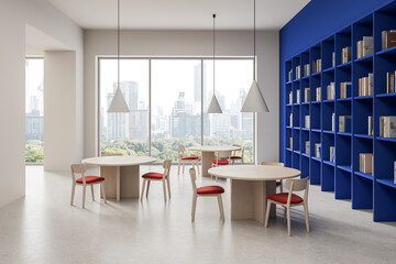 Modern library interior with round tables, wooden chairs, large windows, and tall blue bookshelves overlooking a cityscape on a bright day. 3D Rendering
