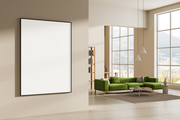 Blank poster mockup hanging on beige wall in stylish modern interior with green sofa and large windows in bright daylight setting. 3D Rendering