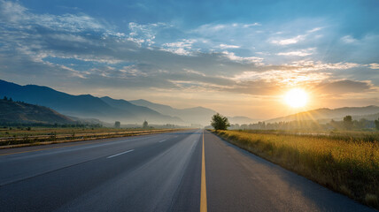 Fototapeta premium Open Highway Leading Toward Sunrise in Mountain Landscape