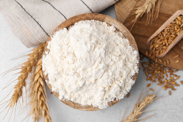 Wheat flour, grain and spikes on white table, flat lay