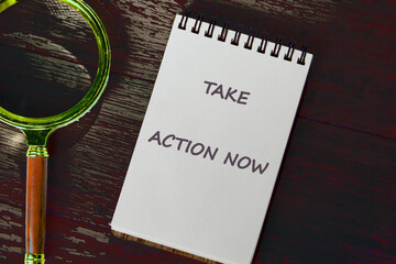 Encouraging motivation, productivity and determination concept. TAKE ACTION NOW written on a...