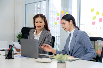 Businesswomen Collaborating on Laptop in Office