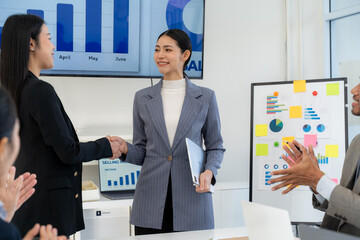 Successful Businesswomen Shaking Hands in Meeting