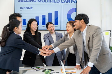 Diverse Business Team Stacking Hands in Meeting