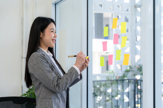 Asian Businesswoman Planning with Sticky Notes