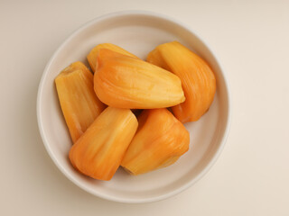 Jack fruit, peeled and cut, on white background