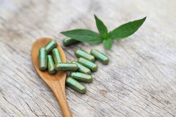 Herbal capsules from green herbal on leaf for healthy eating in daily life