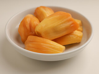 Jack fruit, peeled and cut, on white background