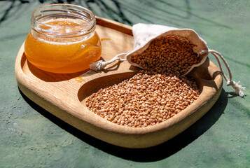 Honey and Honeycomb on a Wooden Board with Floral Arrangement