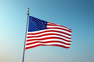 Obraz premium American flag waves against a clear blue sky, evoking patriotism, freedom and national pride.