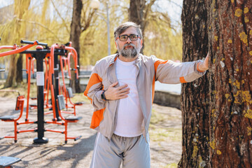 Senior man suffering chest pain while exercising outdoor