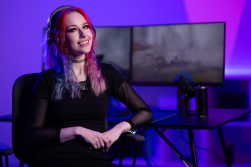 Young gamer streaming in colorful ambiance with professional setup