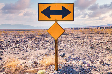 Direction sign in the desert under a blue sky. Concept of uncertain, risk, choice, decision