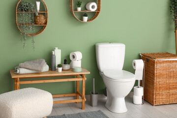 Stylish interior of modern restroom with wicker laundry basket